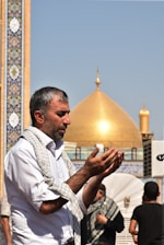 A man standing in front of a golden dome