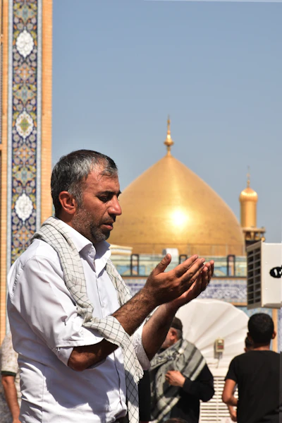 A man standing in front of a golden dome