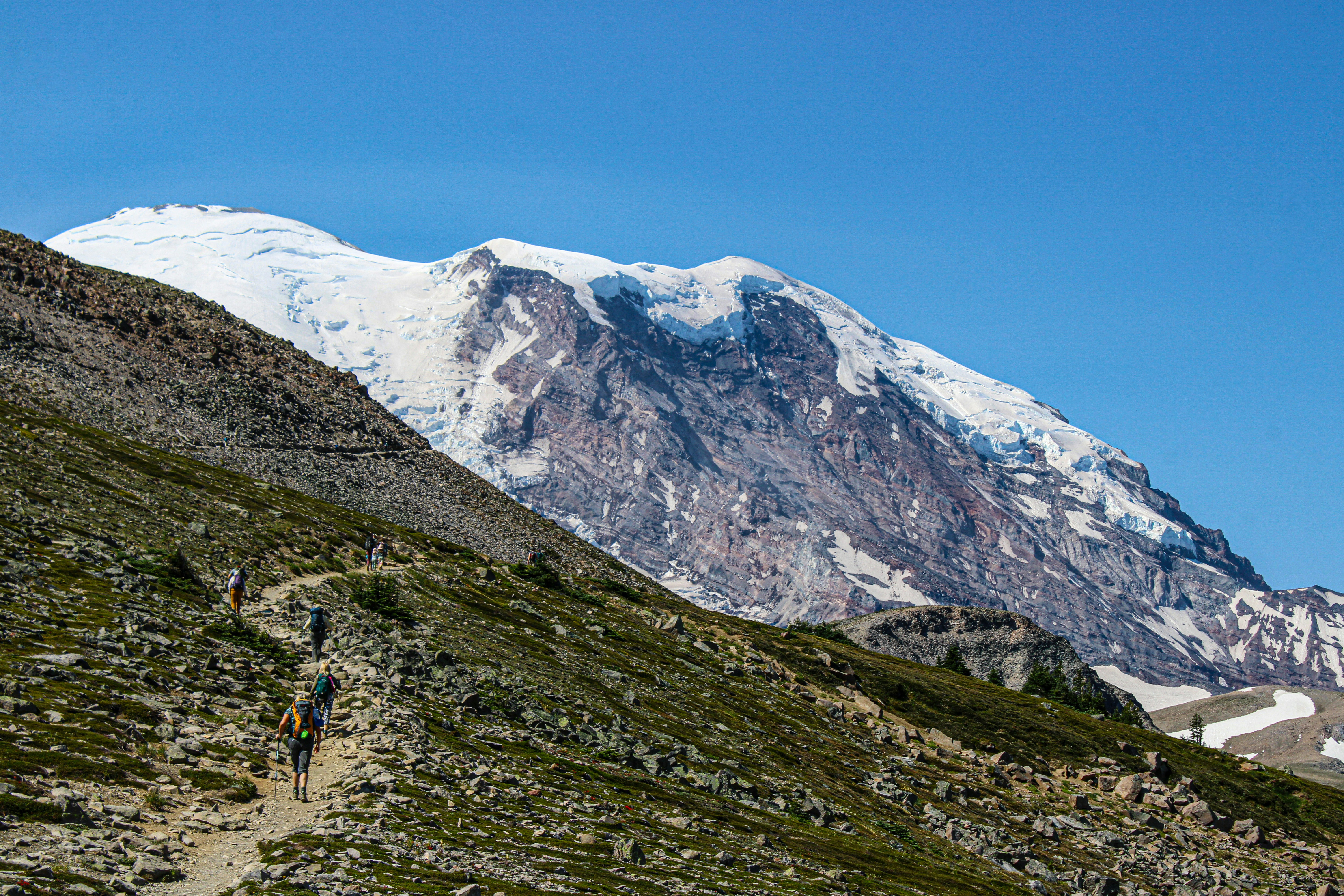 A group of people hiking up a mountain side