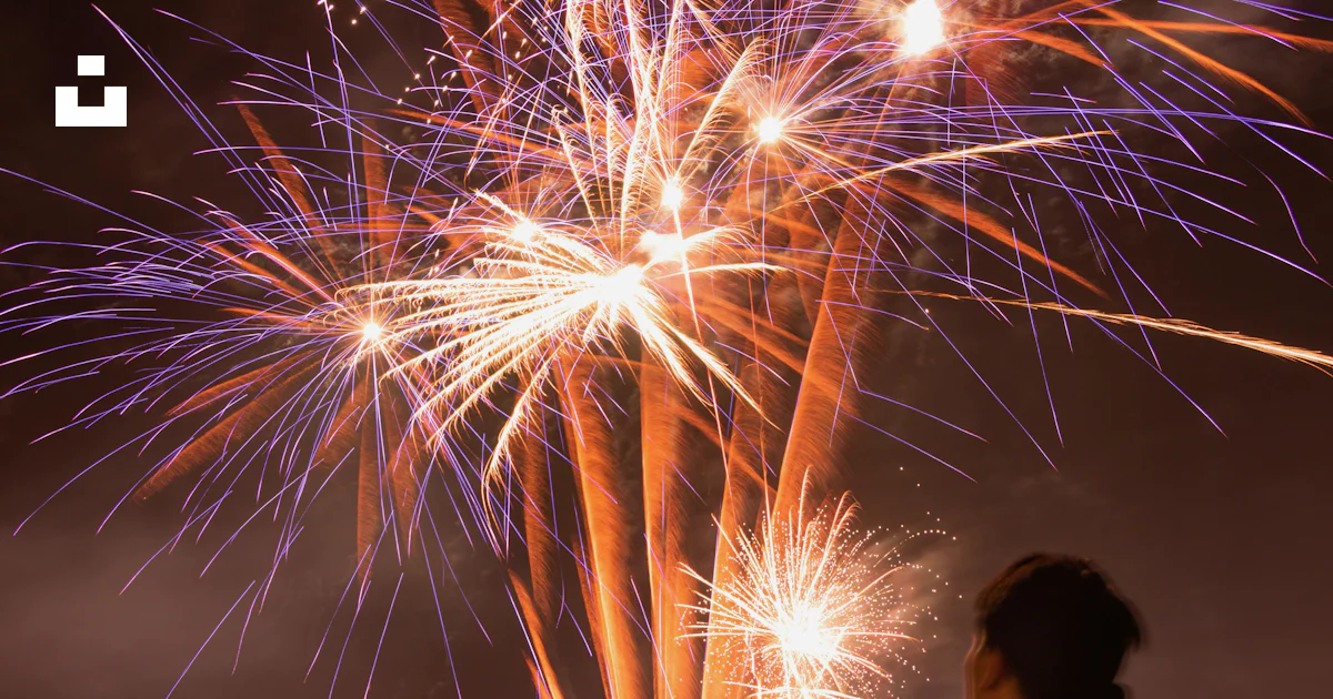 A man standing in front of a firework display photo – Free Fireworks ...