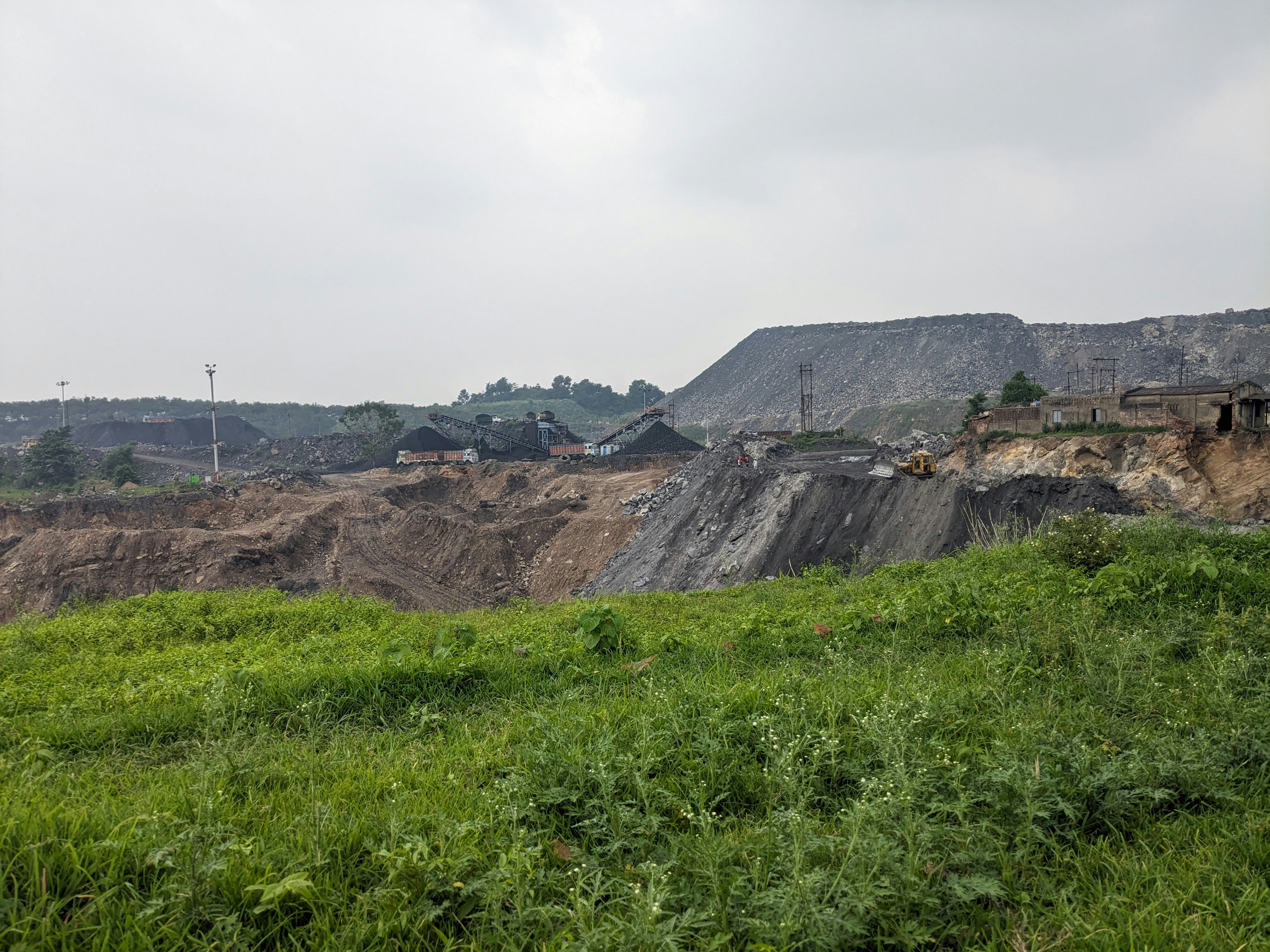 Coal mining operation, dark black coal seams, underground mine setting, industrial excavation