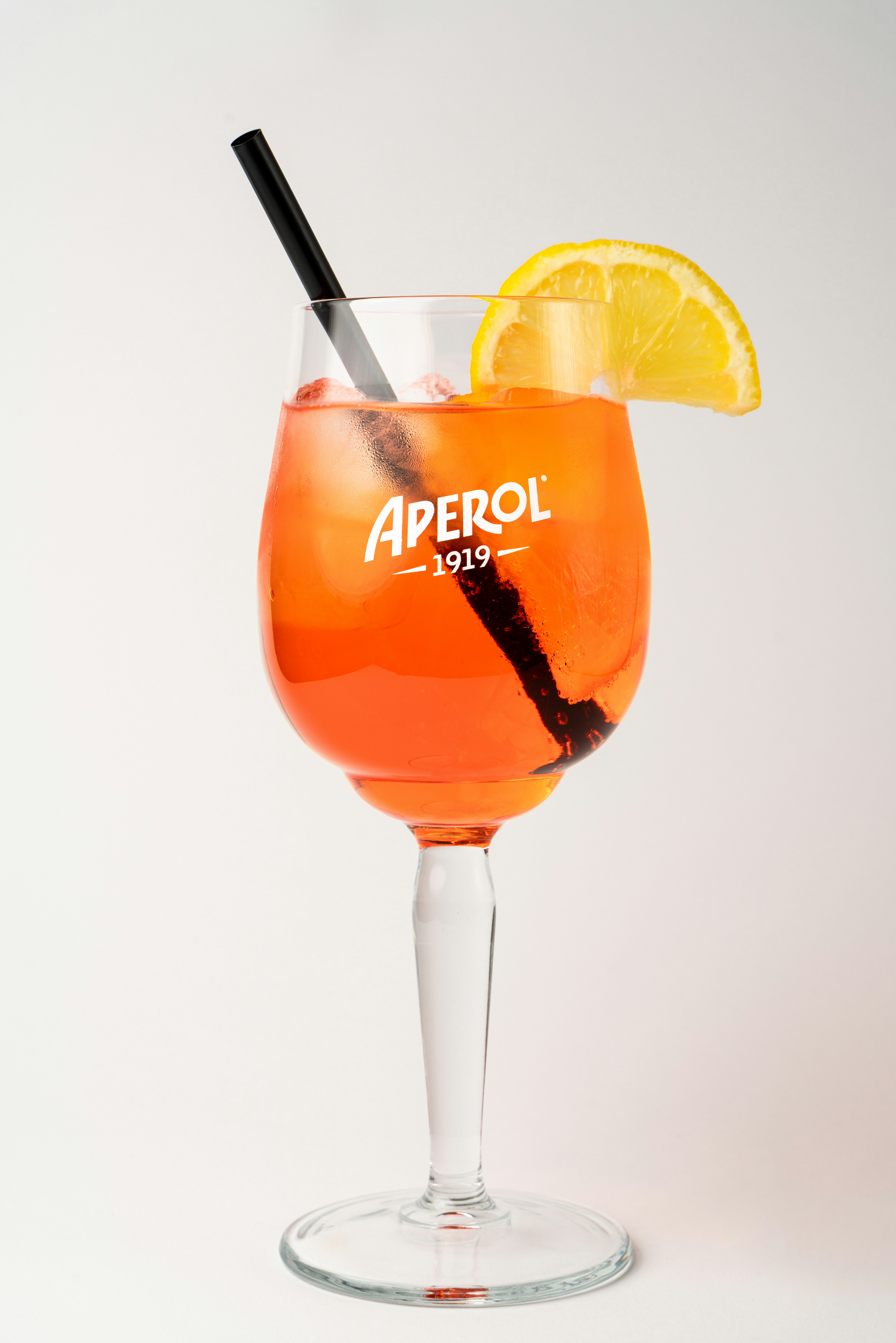 A glass filled with a drink and a slice of lemon