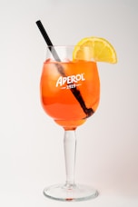 A glass filled with a drink and a slice of lemon