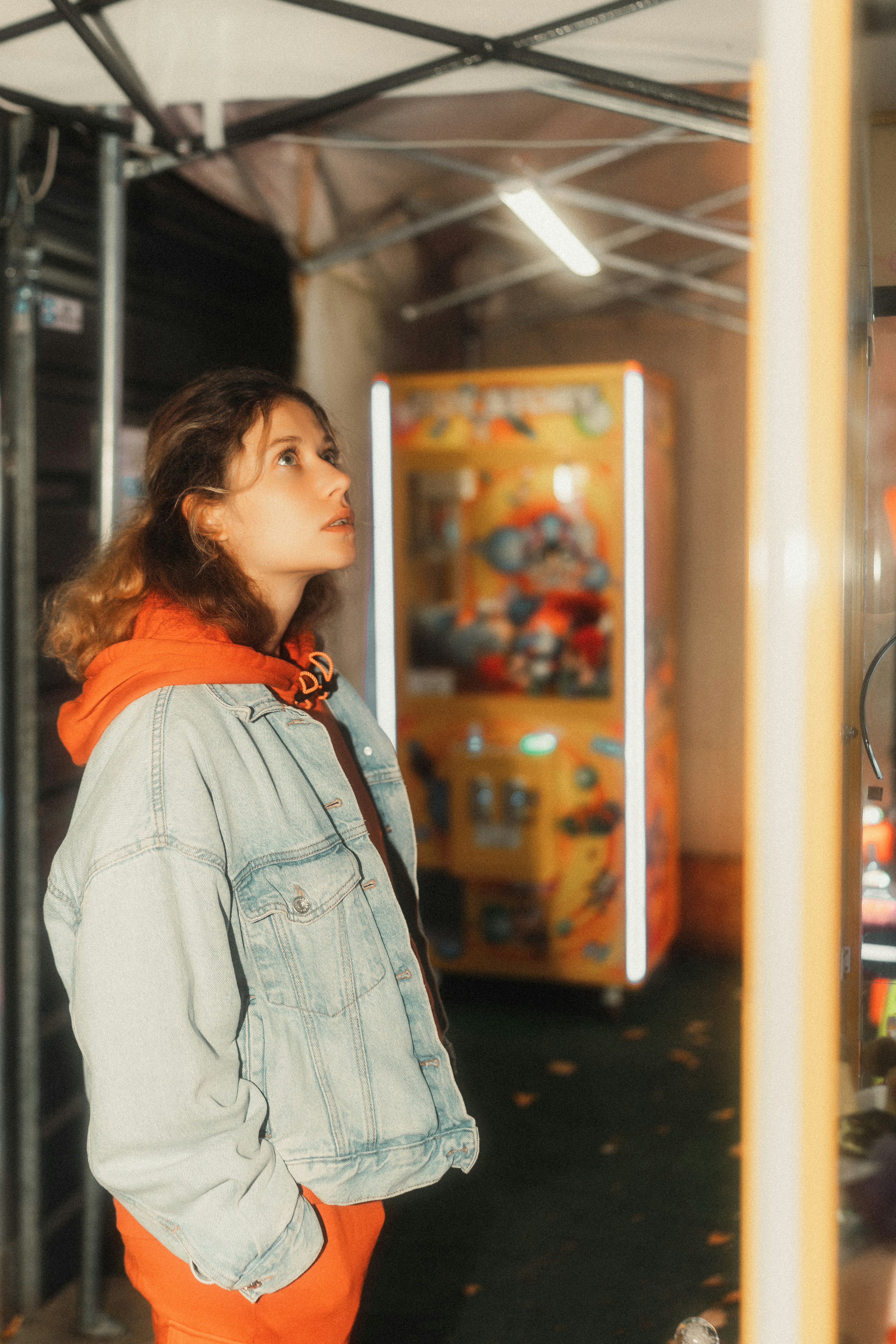 A woman standing in front of a vending machine