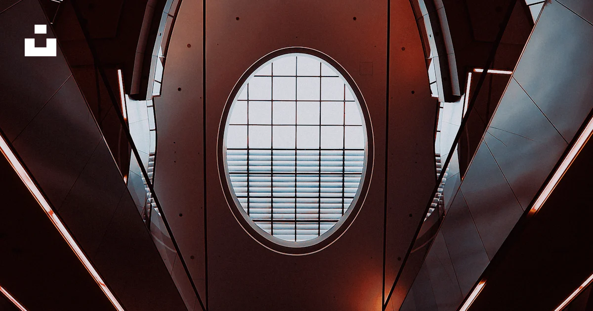 A very tall building with a big round window photo – Free Building ...