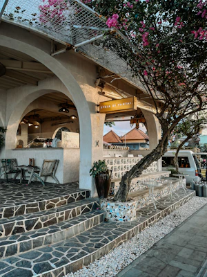 A restaurant with stone steps leading up to it