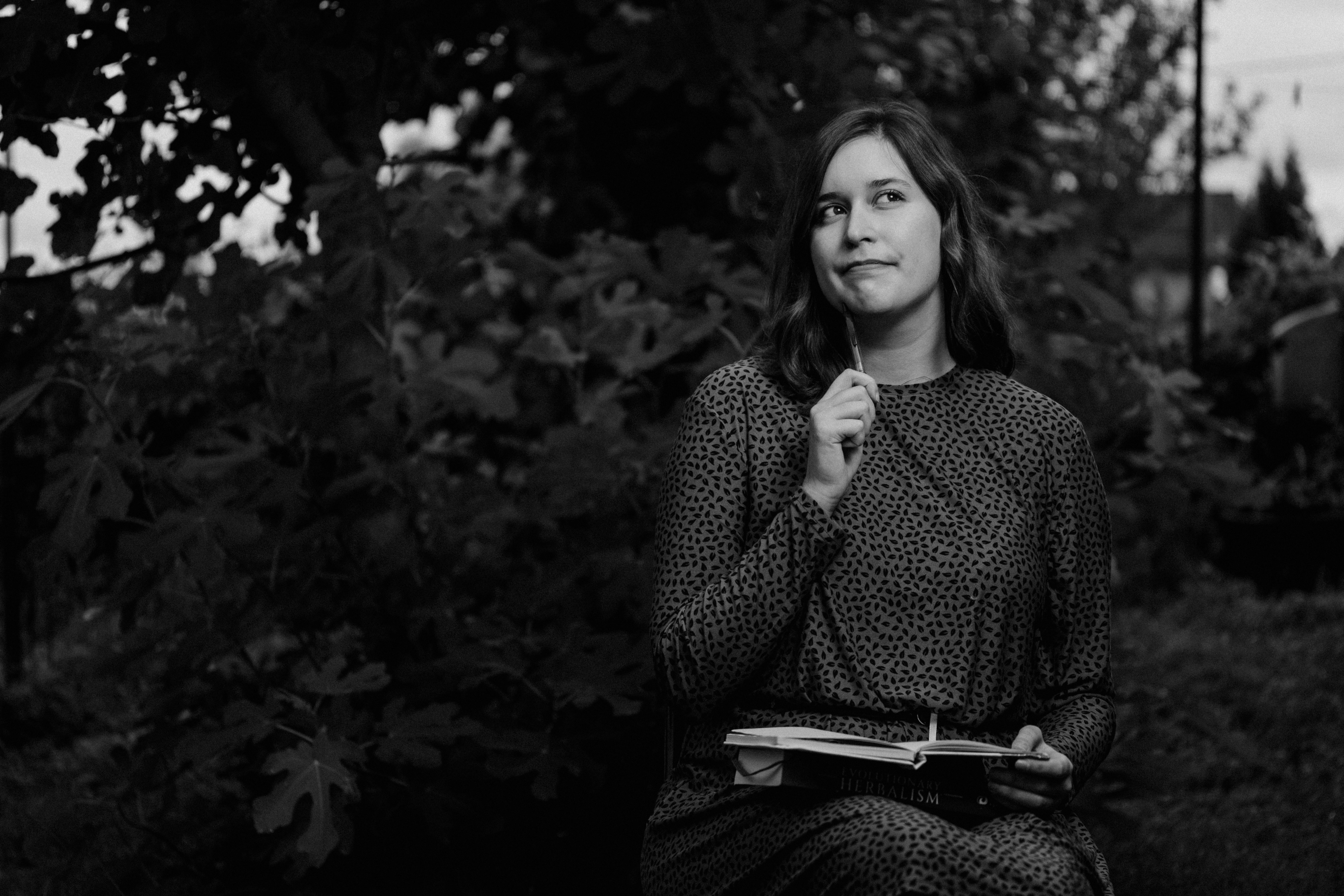 A black and white photo of a woman holding a book