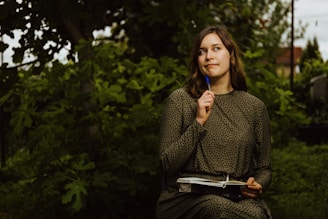 A woman sitting on a bench holding a blue toothbrush