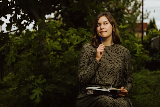 A woman sitting on a bench holding a blue toothbrush