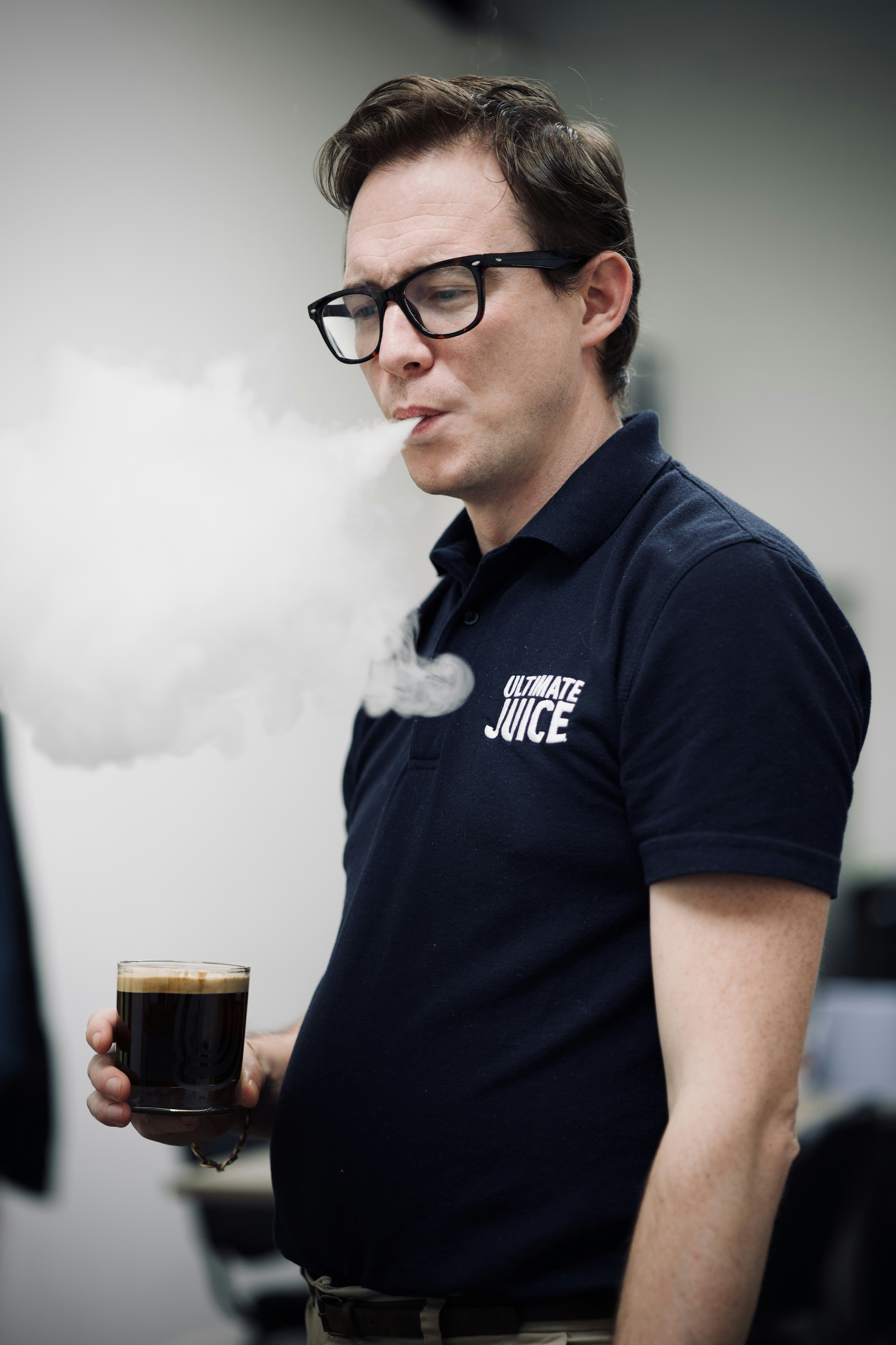 A man holding a cup of coffee in his hand