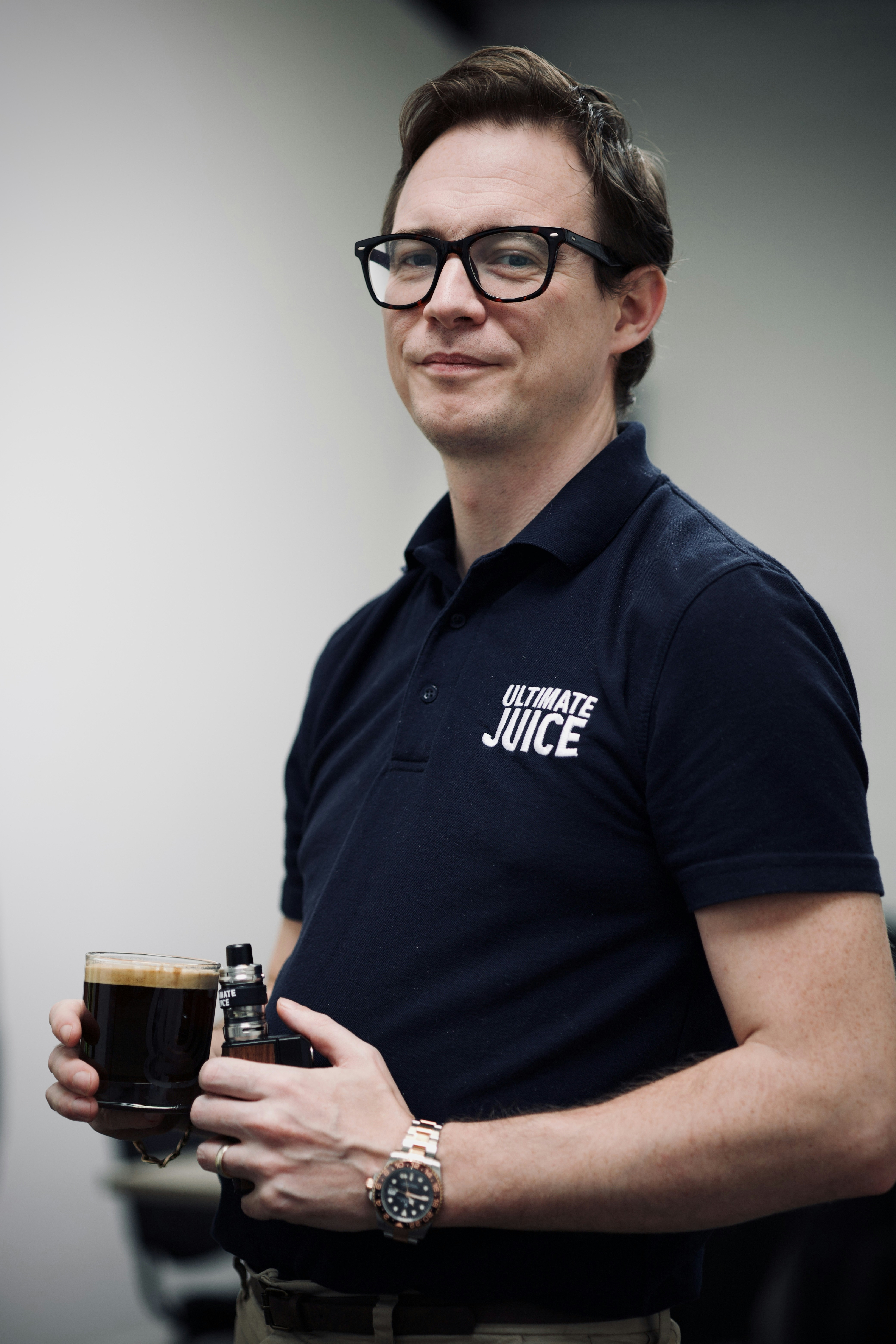 A man with glasses holding a cup of coffee photo Free Coventry Image