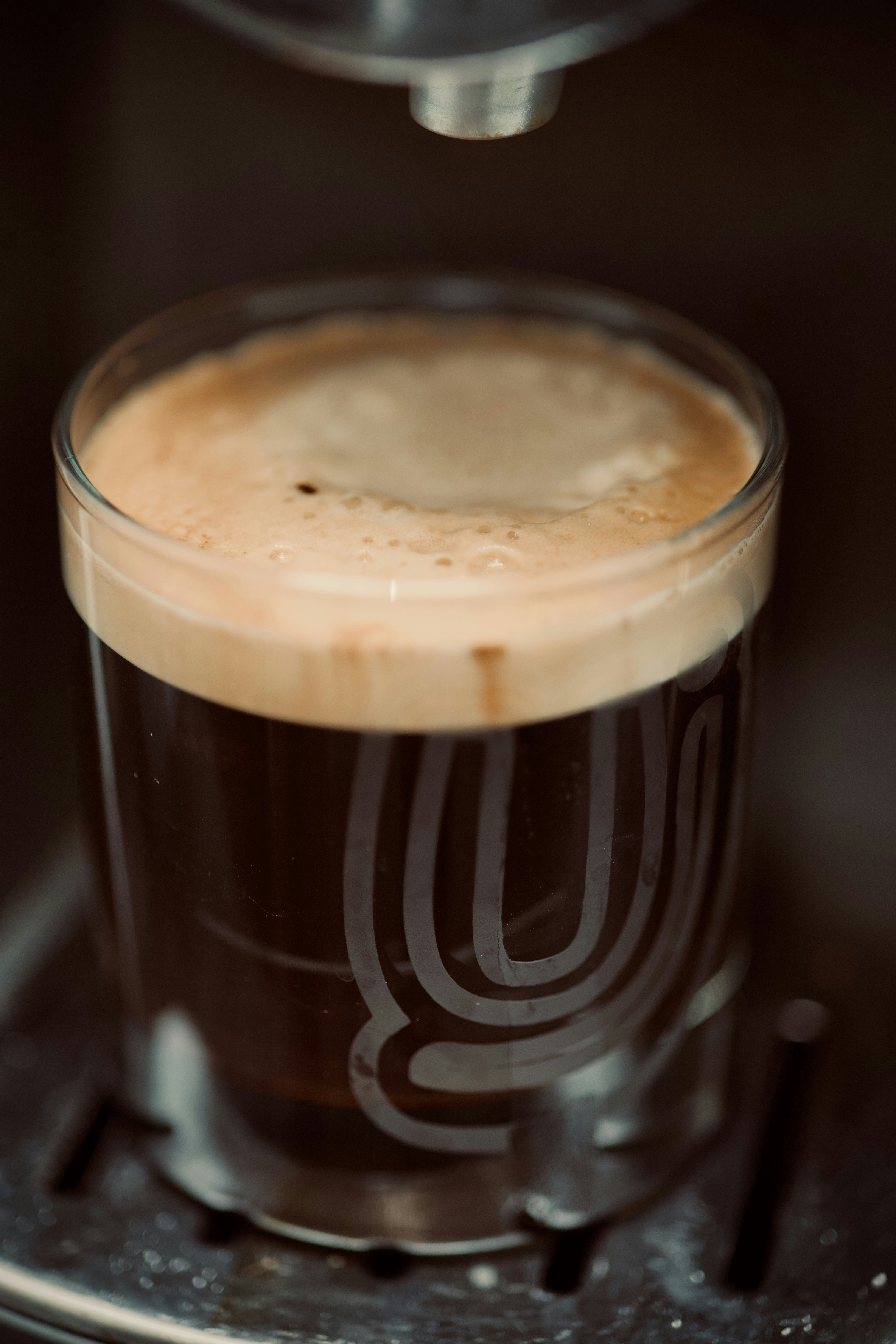 A cup of coffee sitting on top of a stove