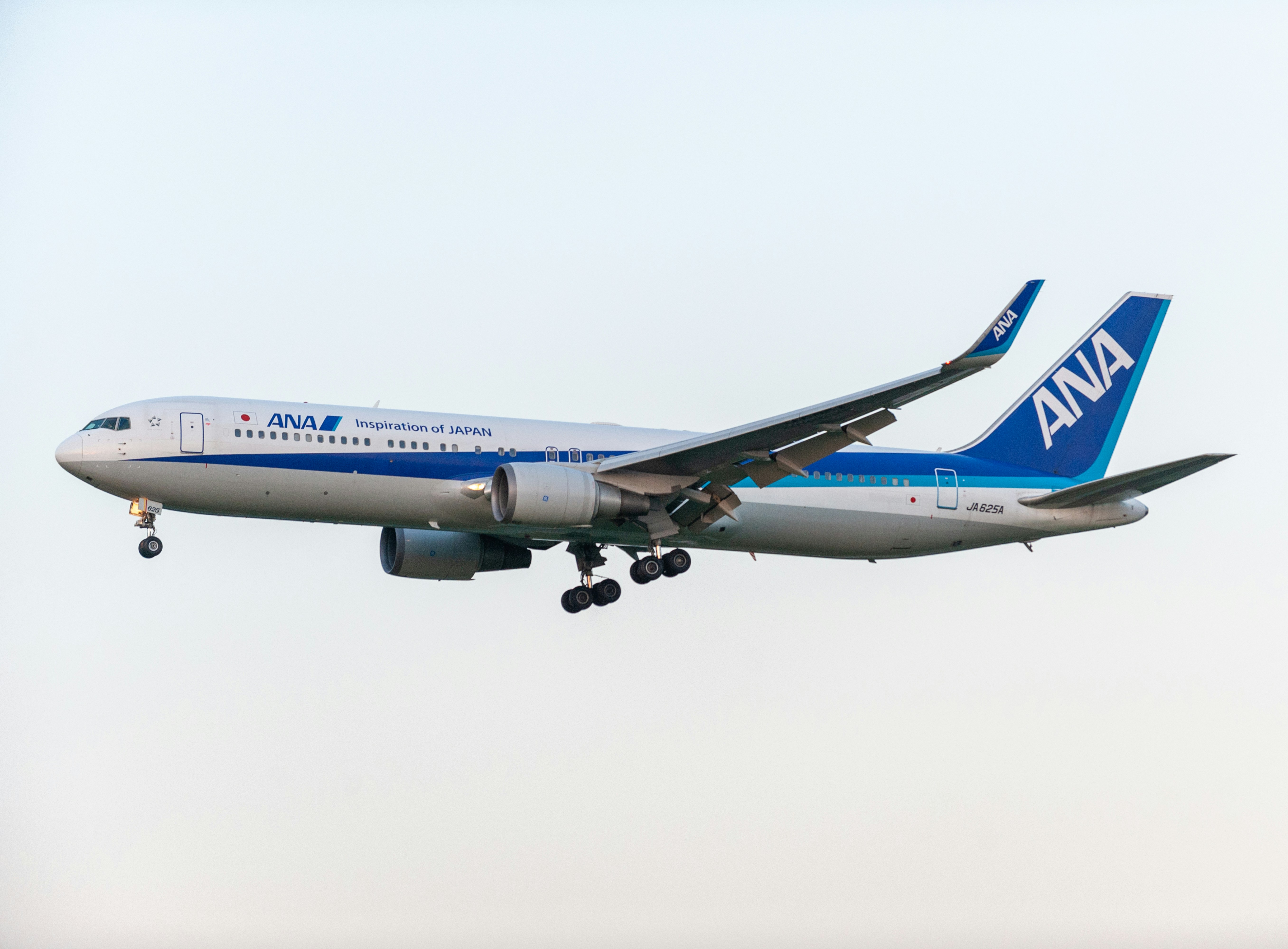 A large passenger jet flying through a blue sky
