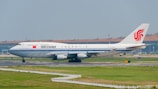 A large jetliner sitting on top of an airport runway