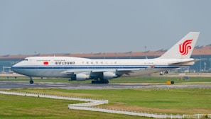 A large jetliner sitting on top of an airport runway