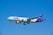 A fedex airplane flying in a clear blue sky