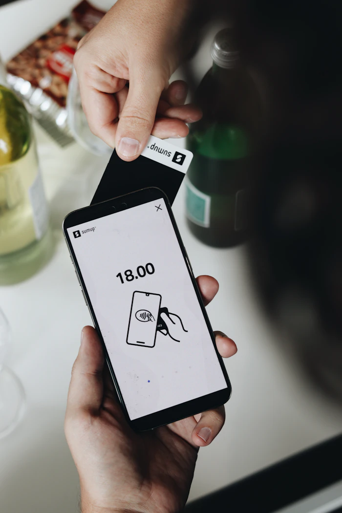 A person making a contactless mobile payment on a smartphone