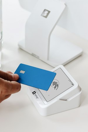 A debit card held against a card reader &mdash; paying for a car rental with a debit card in New Hampshire