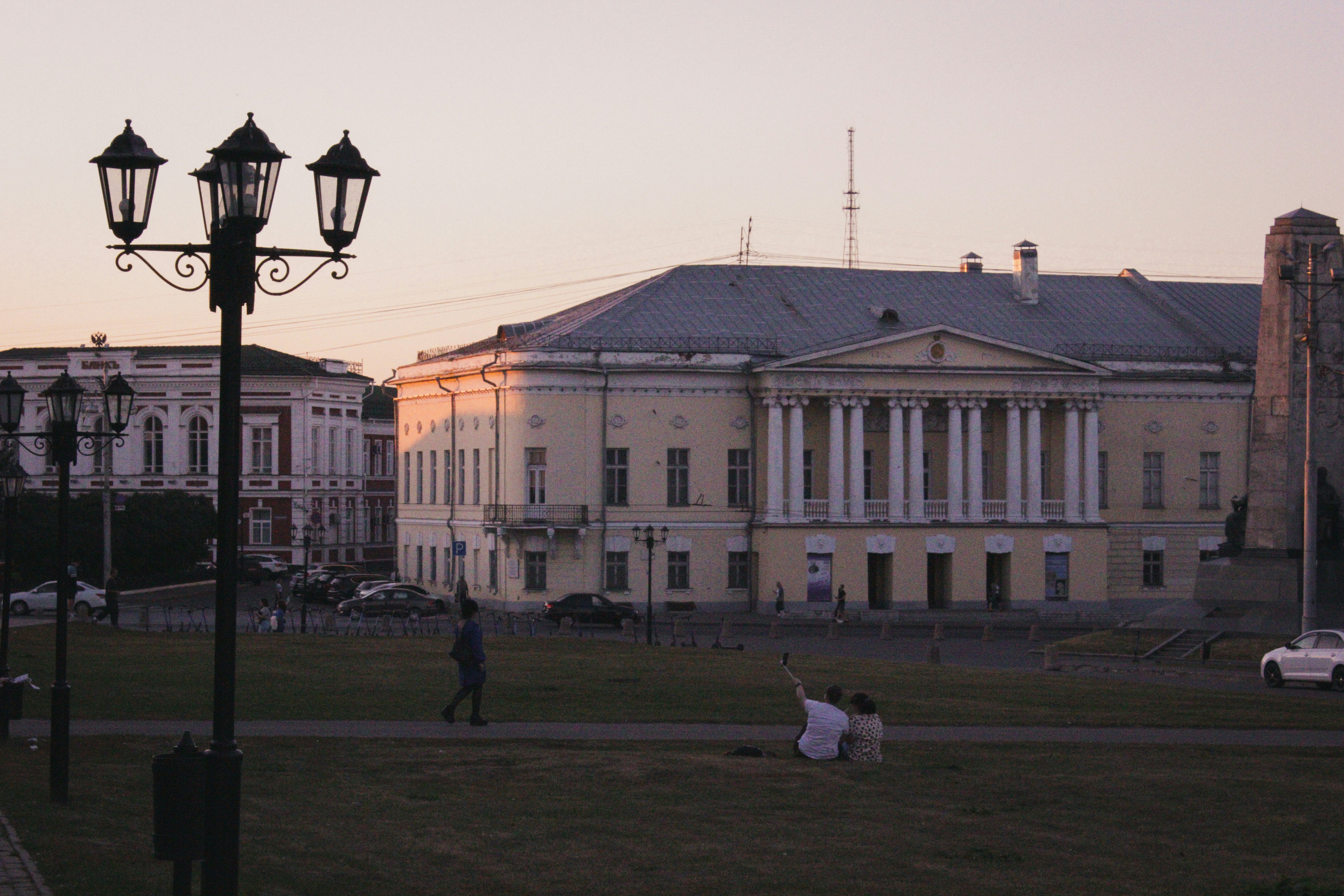 A group of people walking across a grass covered field