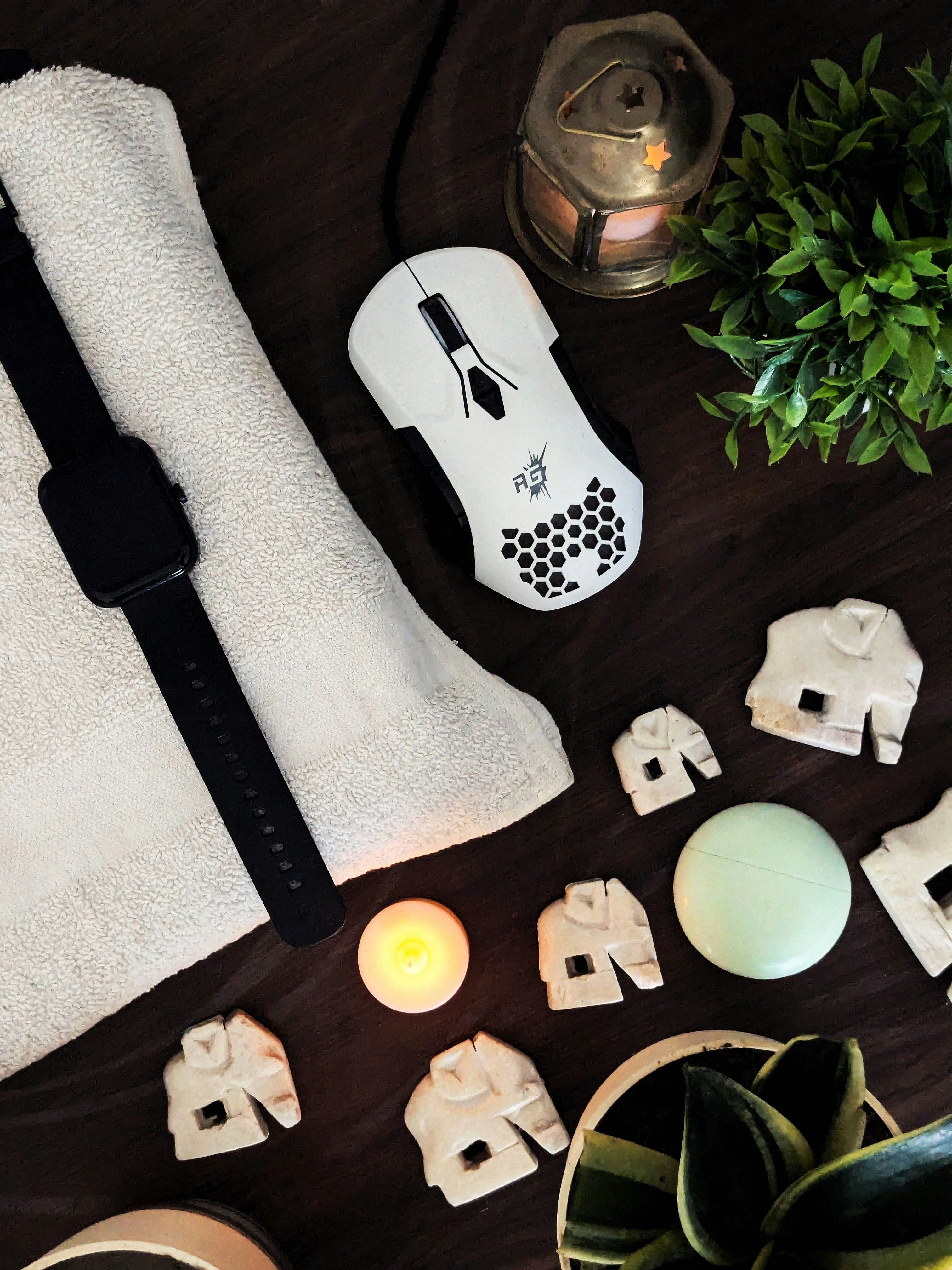 A wooden table topped with white towels and candles