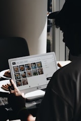 A man sitting in front of a laptop computer
