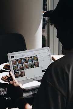 A man sitting in front of a laptop computer