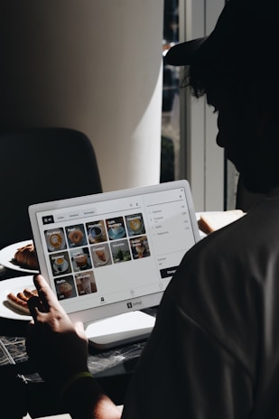 A man sitting in front of a laptop computer