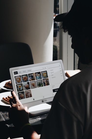 A man sitting in front of a laptop computer