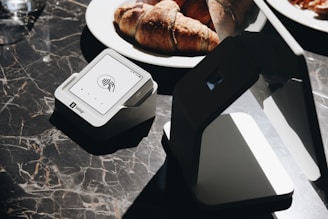 A table topped with plates of food and a laptop