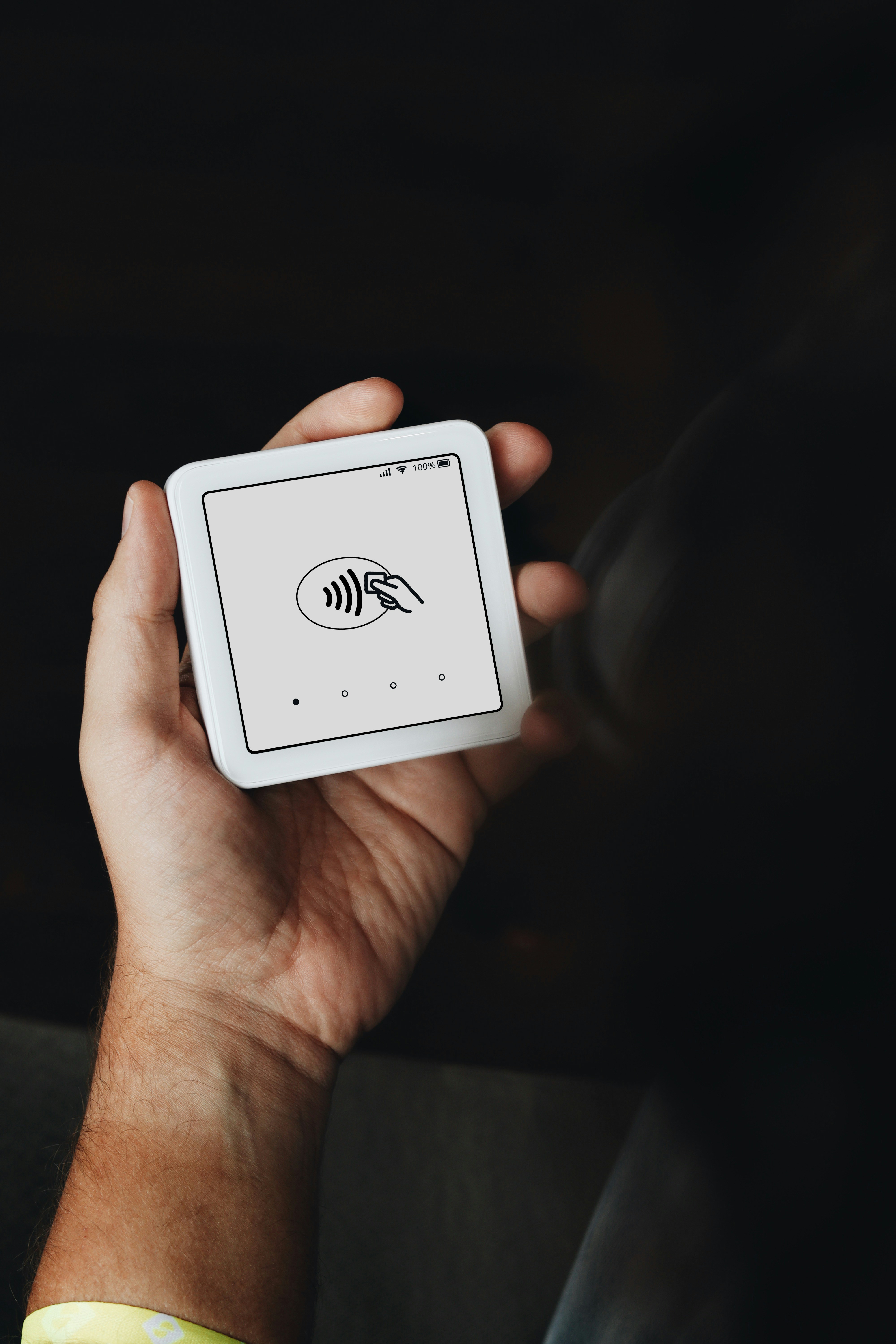 A person holds a SumUp card reader in their hand, ready for a contactless transaction. This image showcases the portability and convenience of SumUp's mobile payment solutions, ideal for entrepreneurs on the go.
