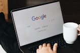 A person sitting in front of a laptop computer