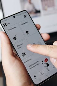 A person holding a cell phone in their hand