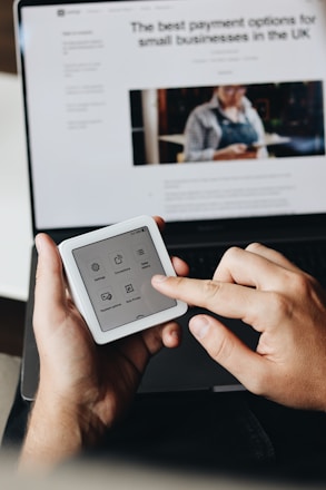 A person holding a tablet and a cell phone