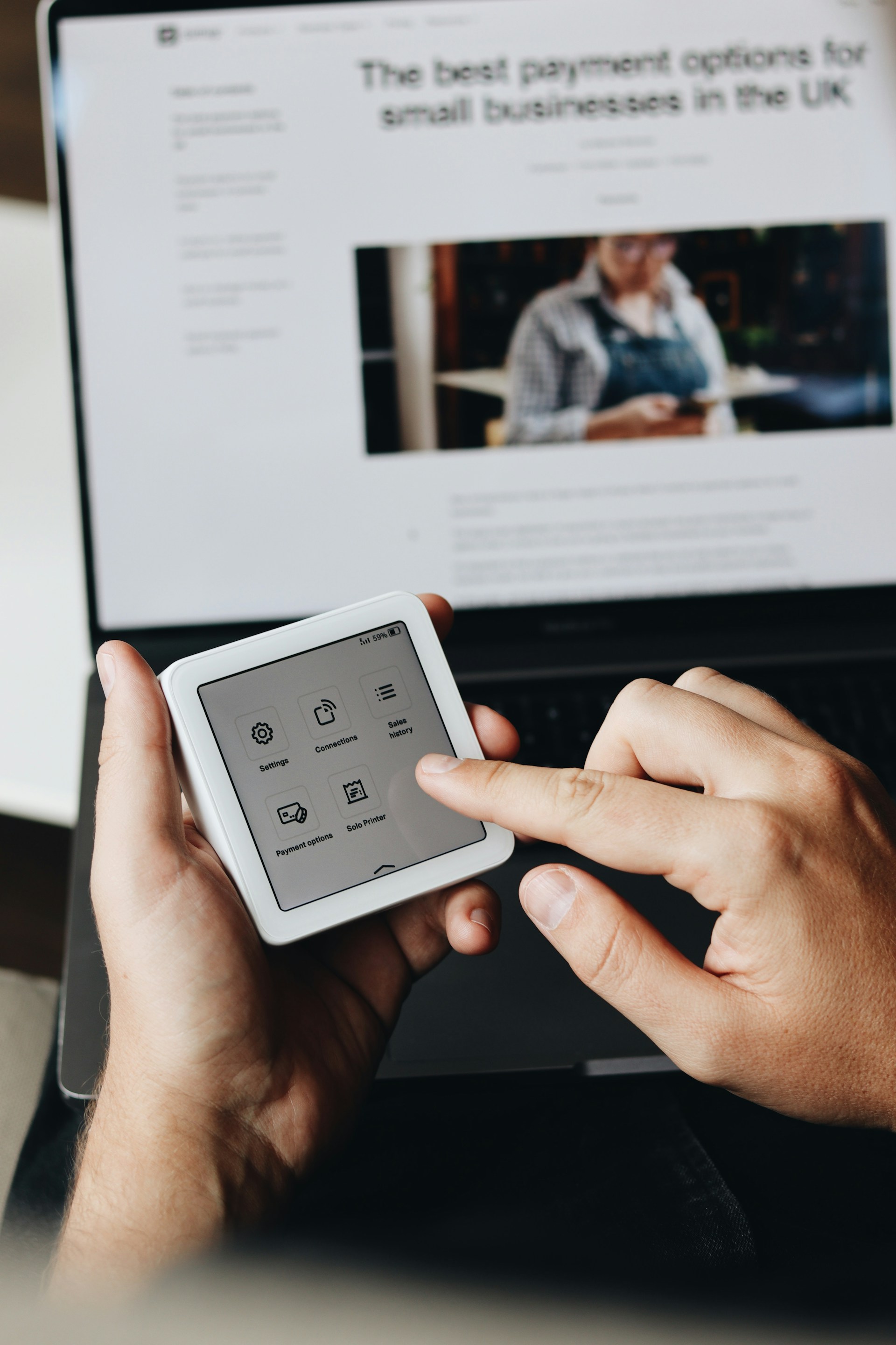 A person holding a tablet and a cell phone