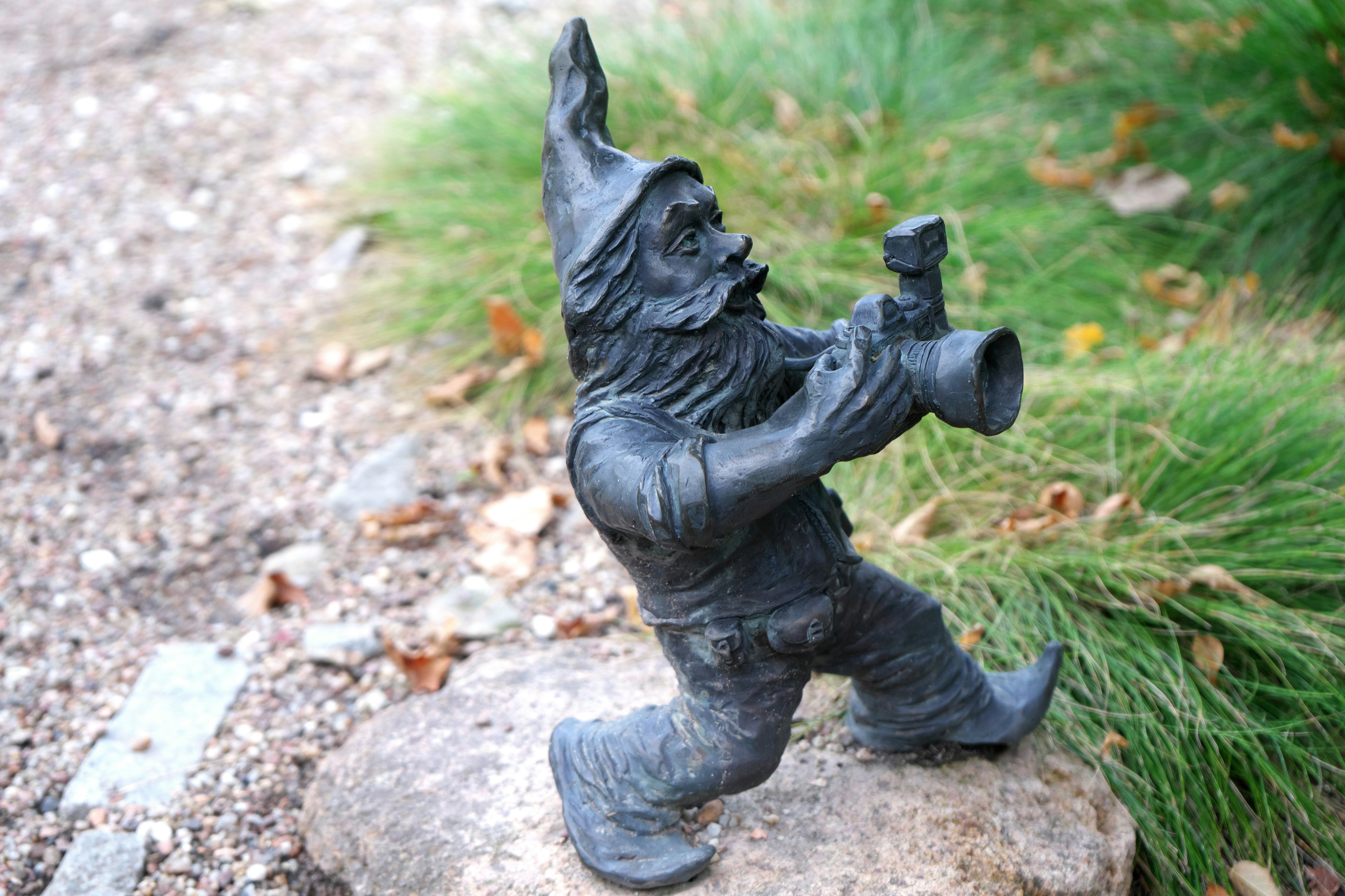 A statue of a man holding a baseball bat, He does look familiar... and he seems to love photography too. Is it how I looked when I was younger? Wrocław Dwarves or Wrocław Gnomes (Polish: Wrocławskie krasnale) are small figurines (20–30 cm) that have appeared in the streets of Wrocław, Poland since 2005. The dwarves