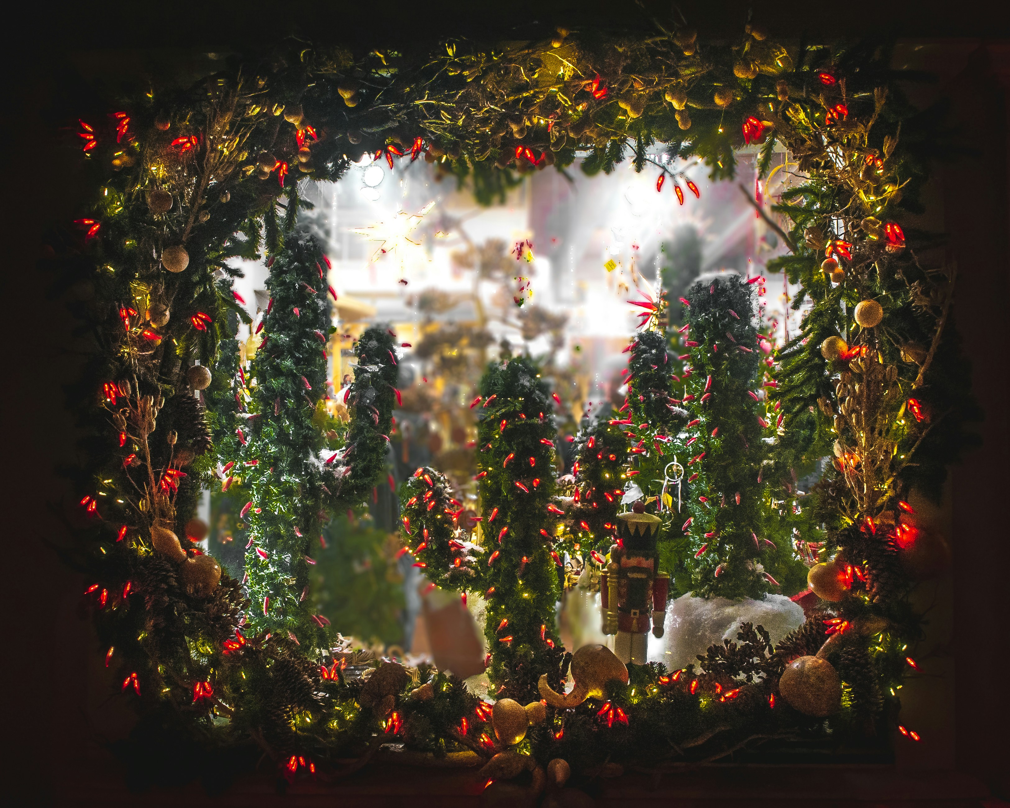 A picture of a window with christmas decorations
