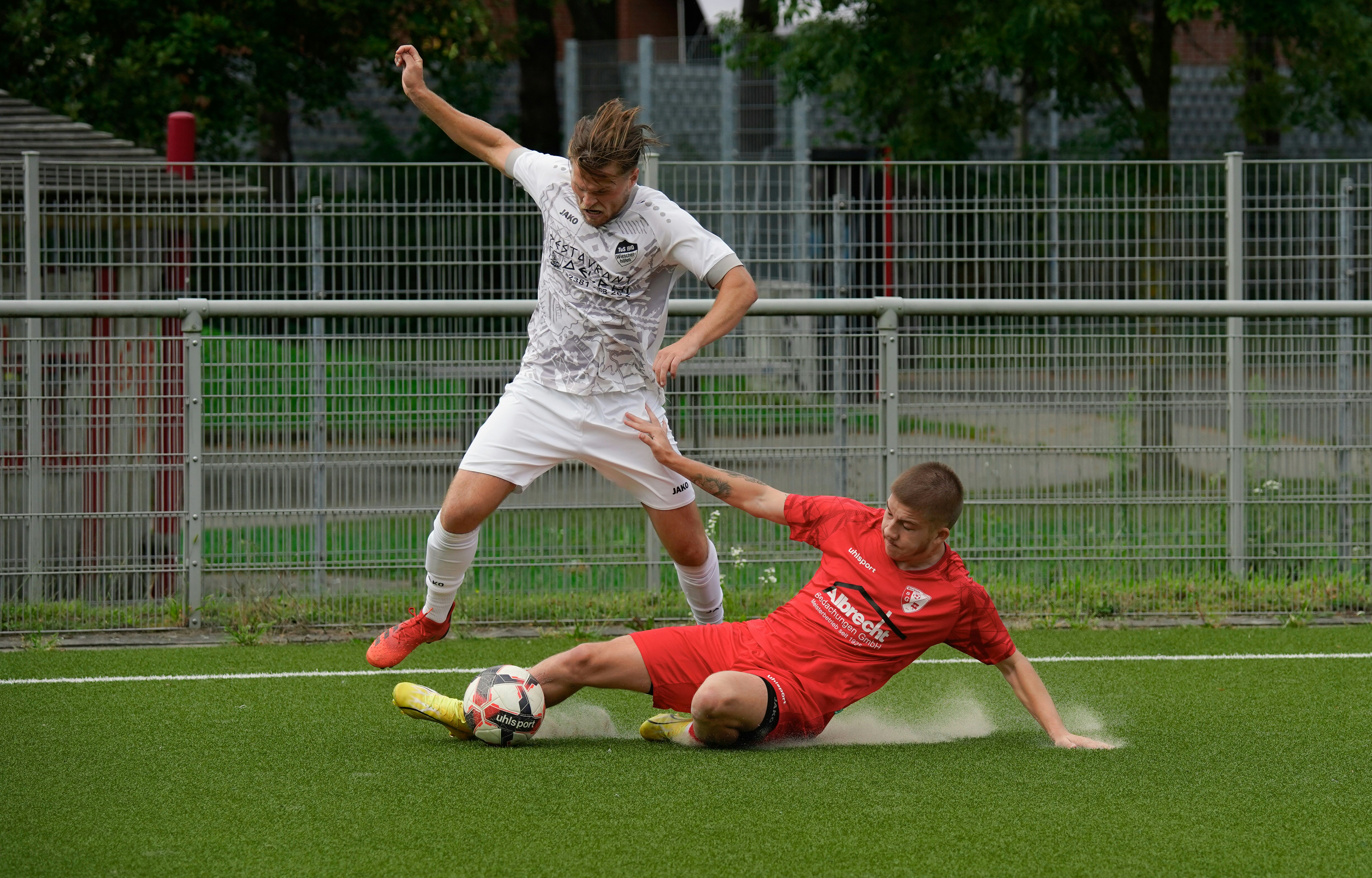 player sliding tackle in football match
