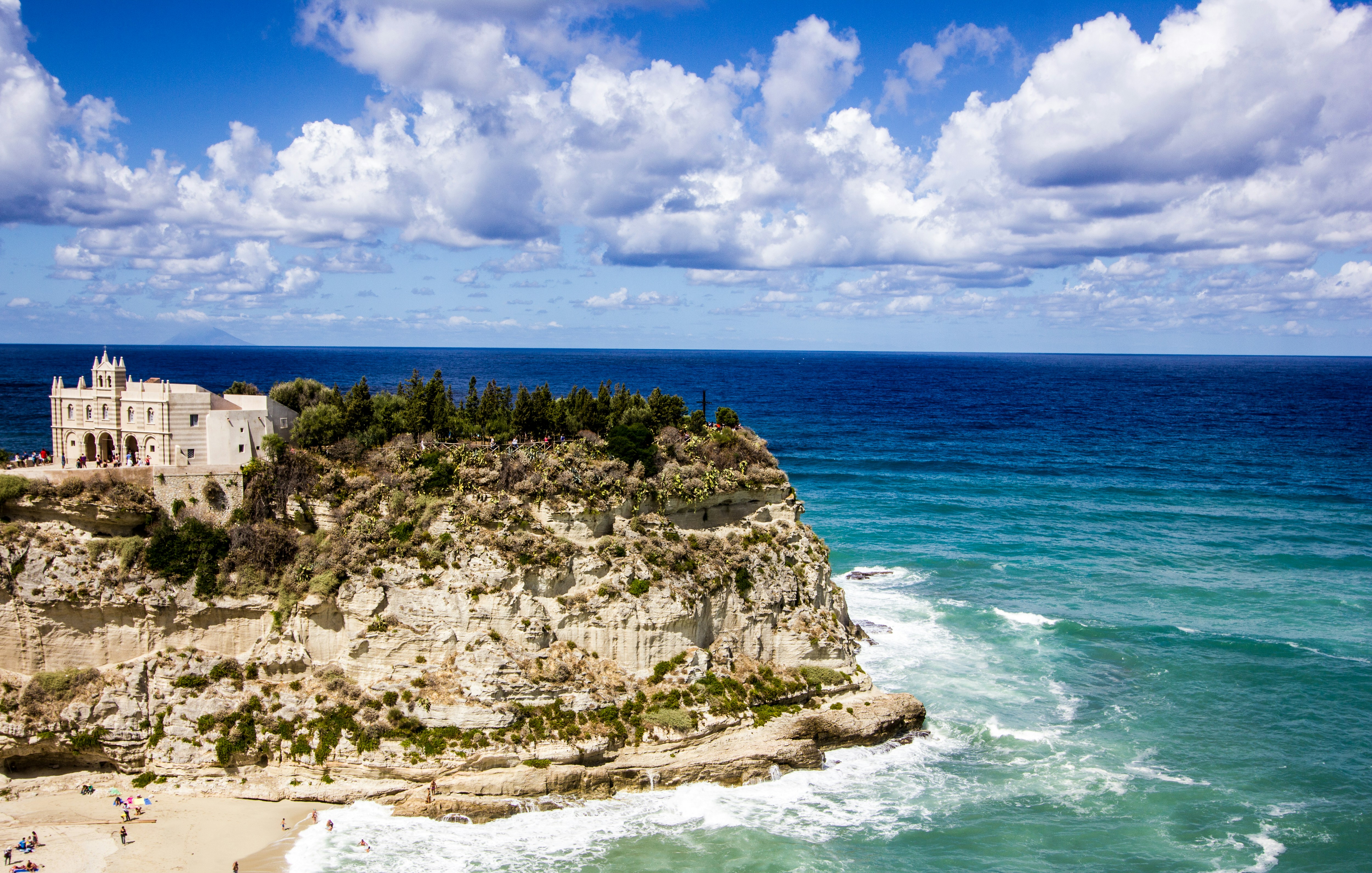 A castle on a cliff overlooking the ocean