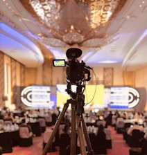 A camera set up on a tripod in a banquet hall