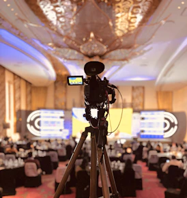 A camera set up on a tripod in a banquet hall