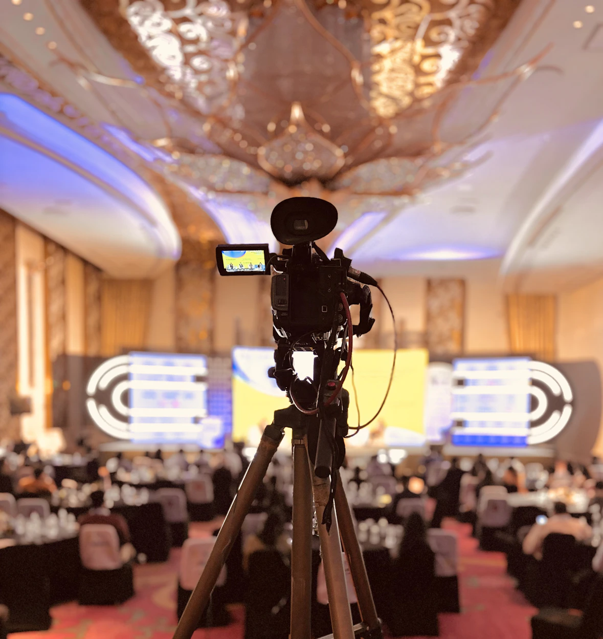 A camera set up on a tripod in a banquet hall