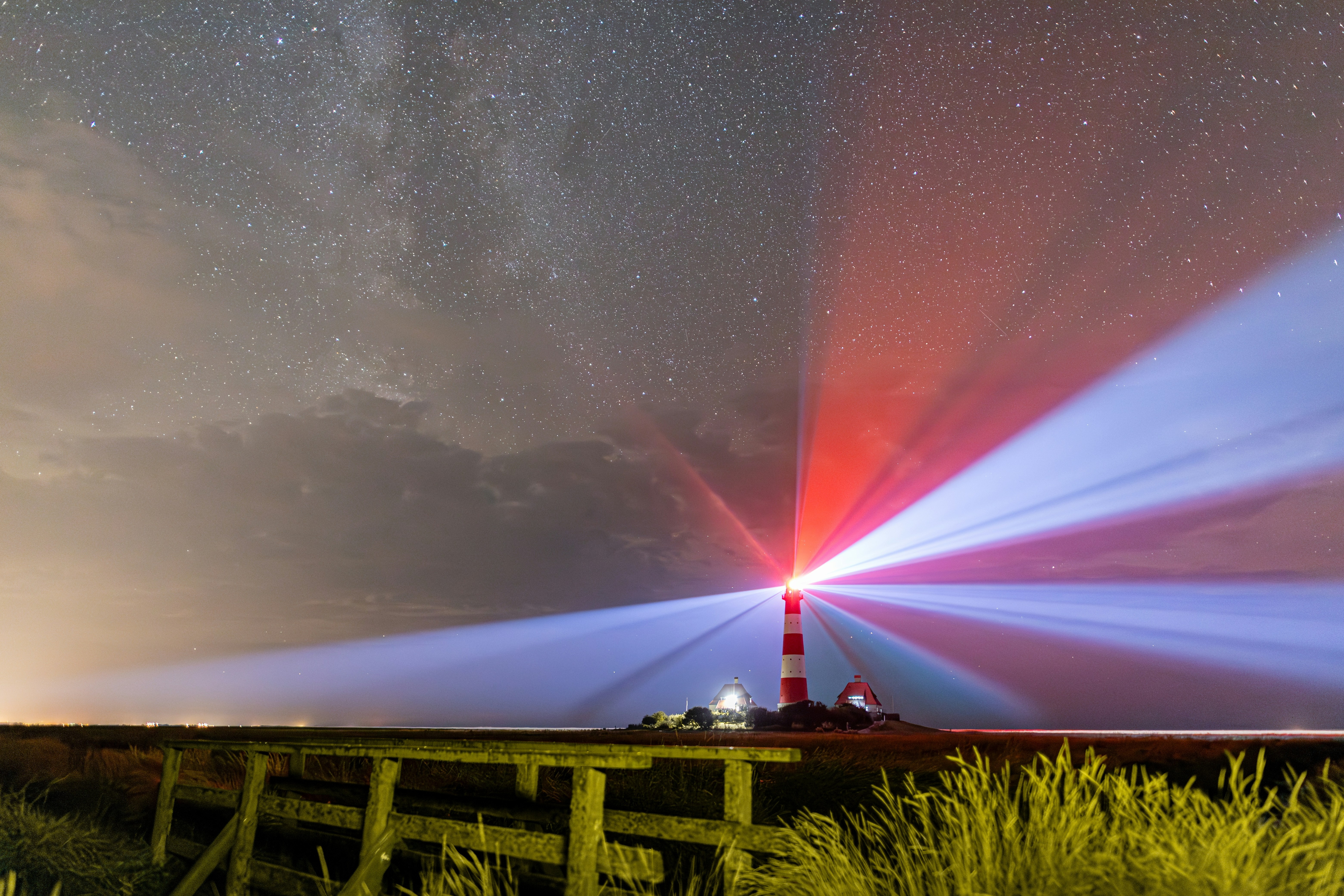 A red white and blue light shines in the night sky