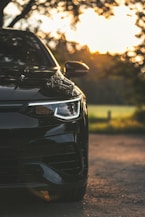 A black car parked on the side of a road