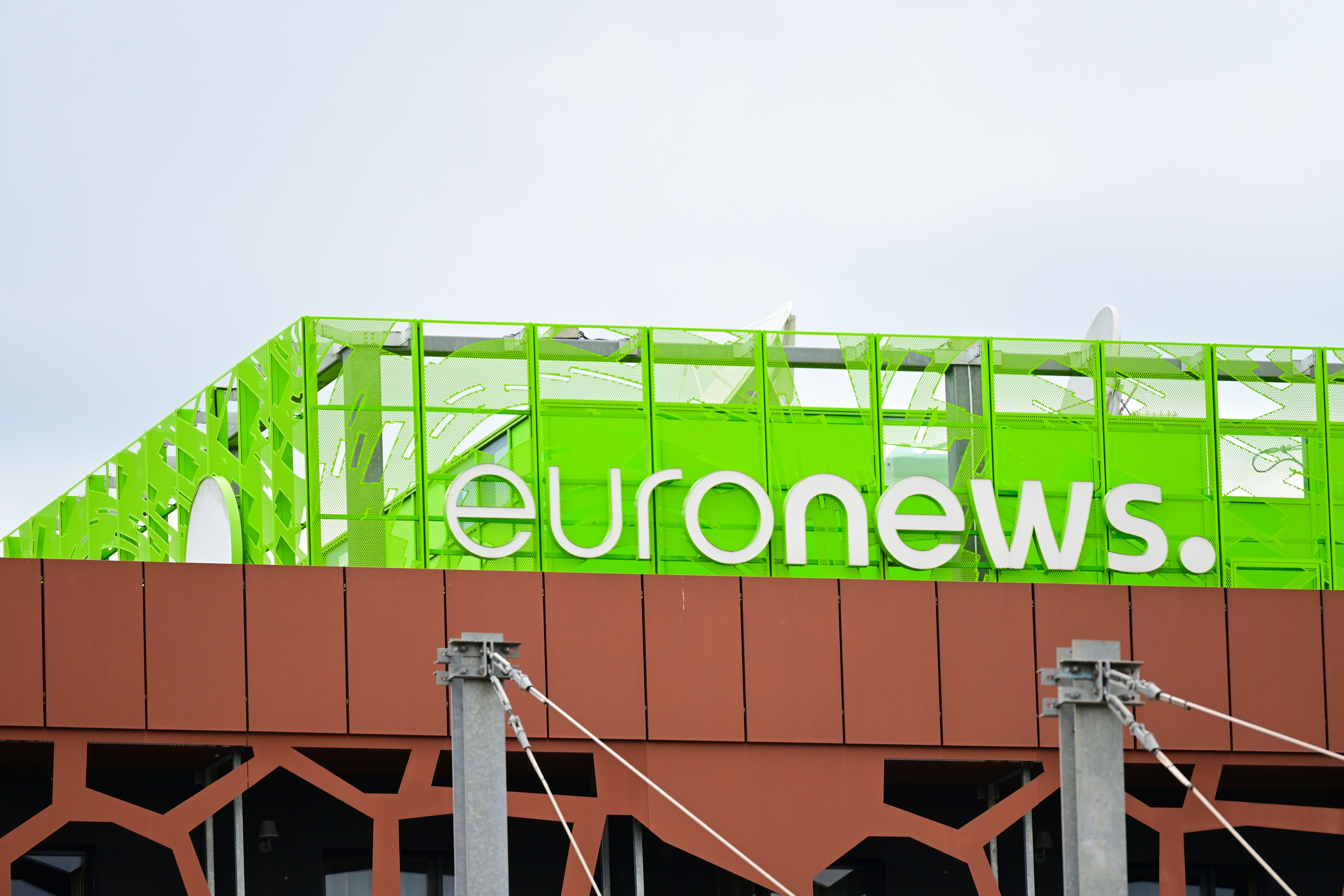 A green sign on top of a building that reads euronews