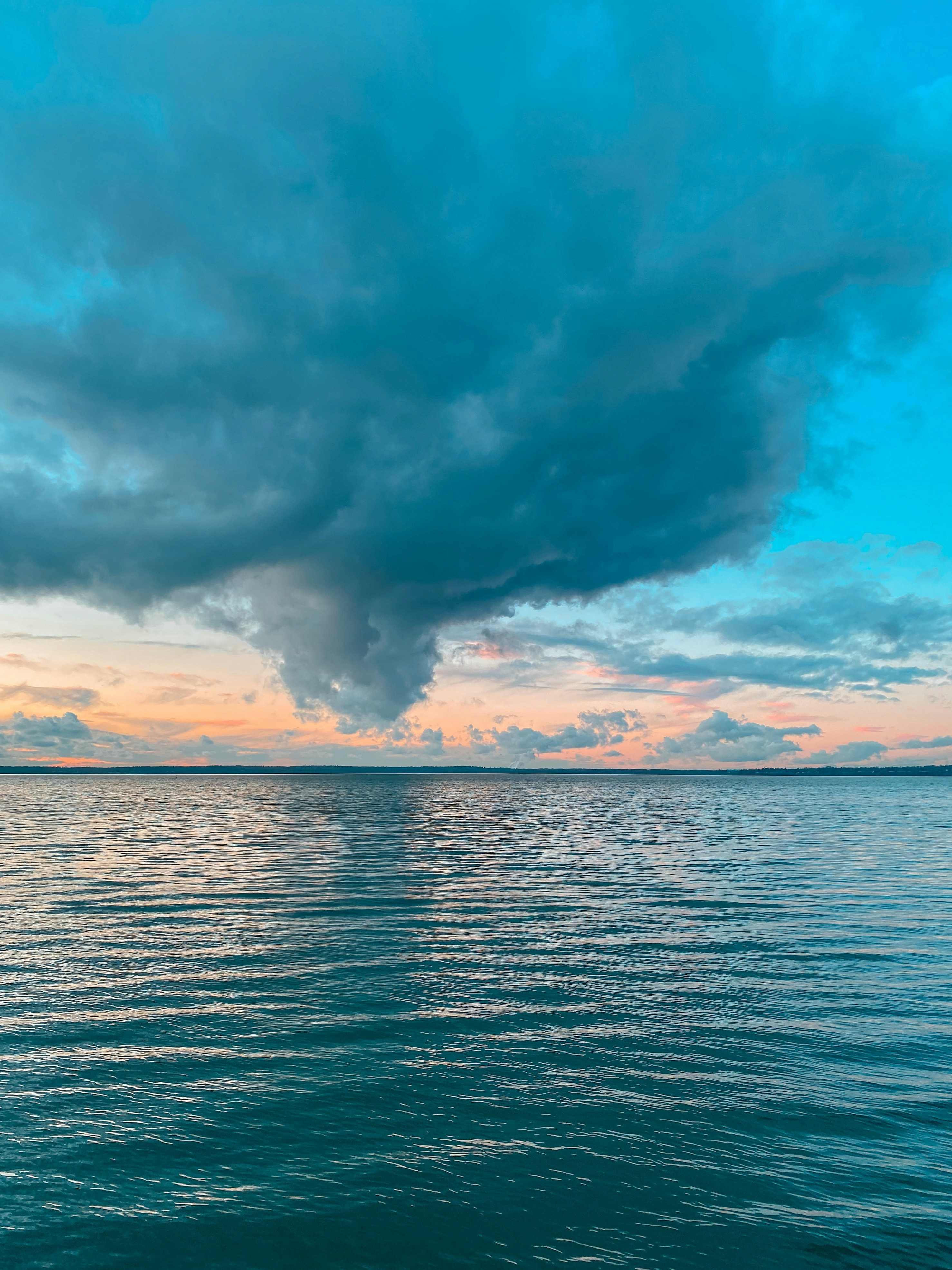 A large body of water under a cloudy sky