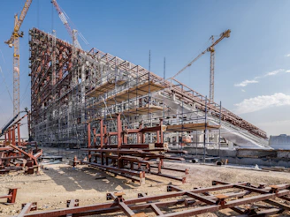A large building under construction with lots of cranes