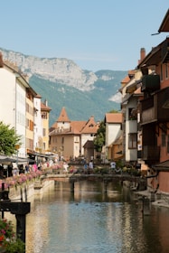 A river running through a small town next to tall buildings