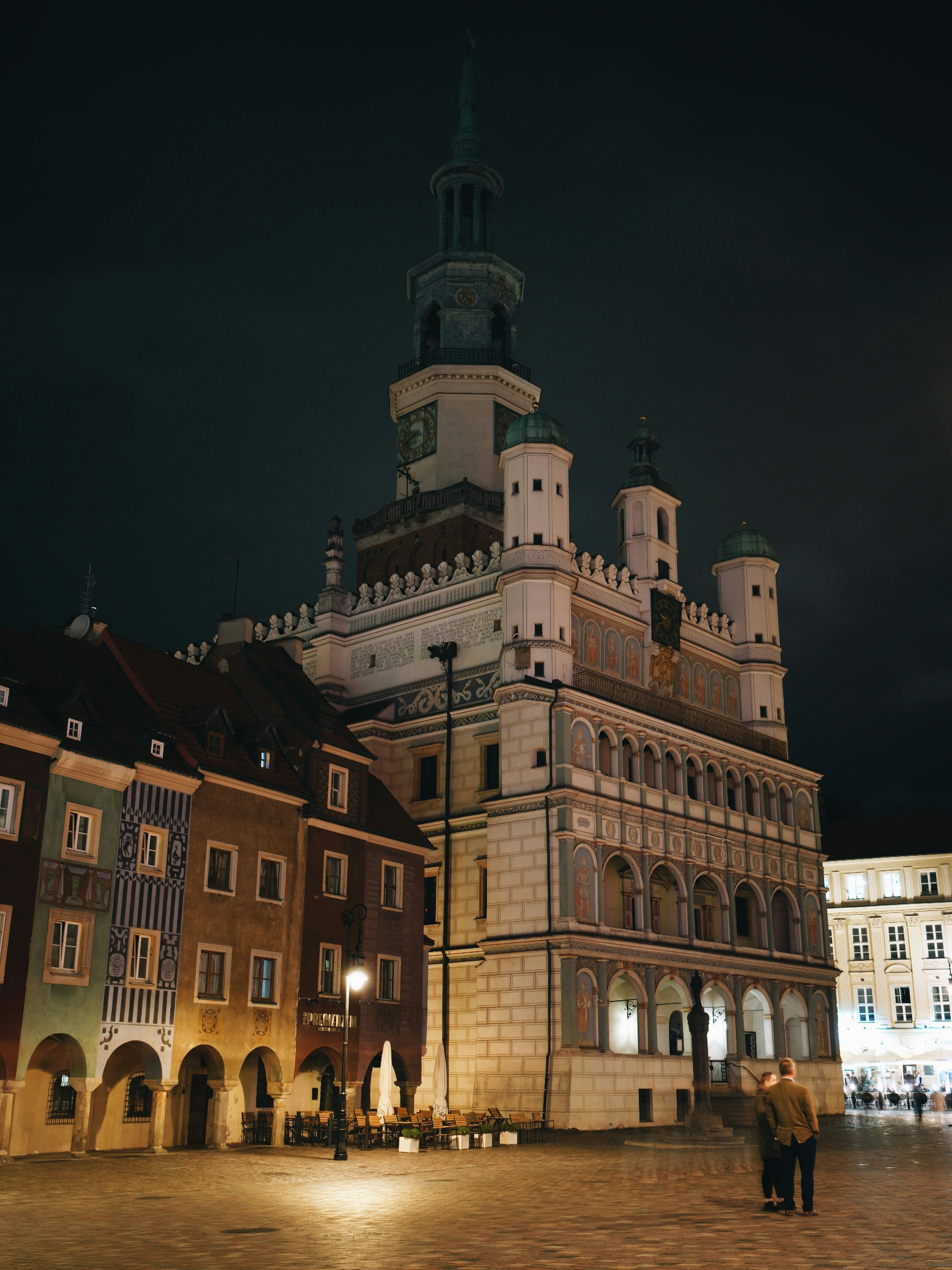 A large building with a clock tower at night