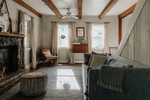 A living room filled with furniture and a fire place