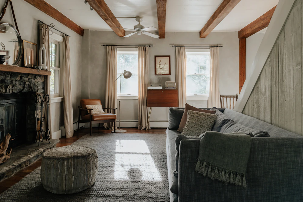 Renovated living room with built-in banquette seating, warm textiles and reading nook